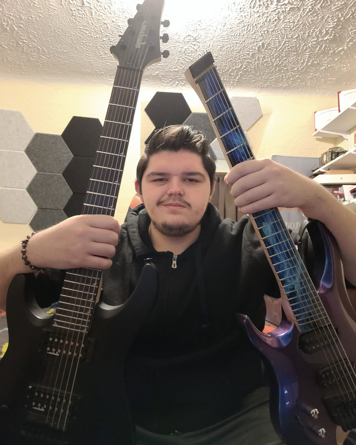 Hunter Herrlinger with guitar and recording equipment